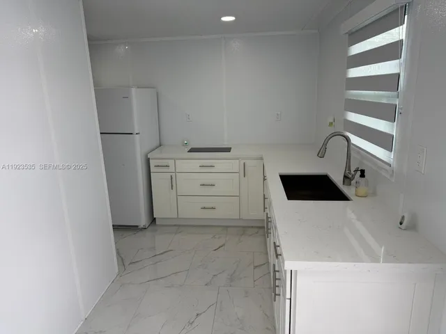 a kitchen with a cabinets and white appliances
