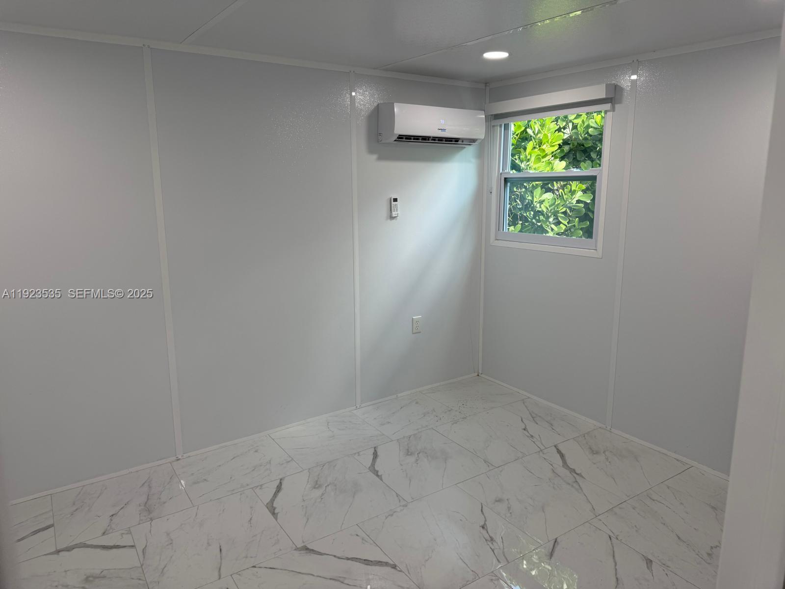 30705 Southwest 194th Avenue Homestead, FL 33030 - Photo 4 of 6 a view of an empty room with a window