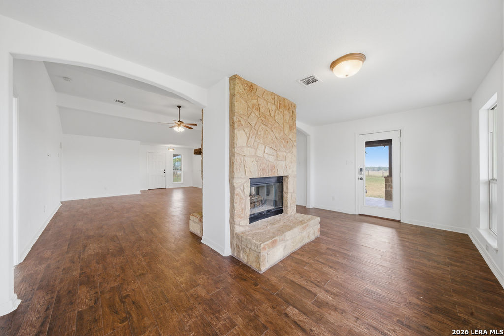 12897 La Vernia Road St. Hedwig, TX 78152 - Photo 11 of 34 an empty room with wooden floor and fireplace