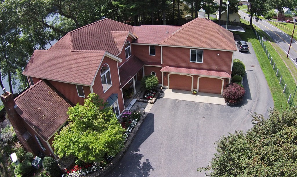 a aerial view of a house with a yard and potted plants