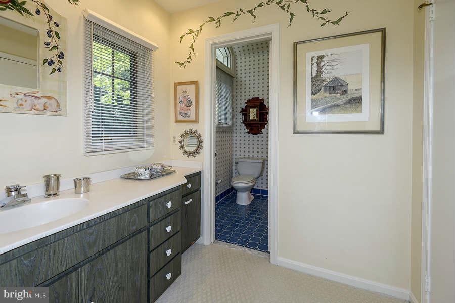 9017 Clewerwall Drive Bethesda, MD 20817 - Photo 17 of 27 a bathroom with a sink a vanity and a mirror