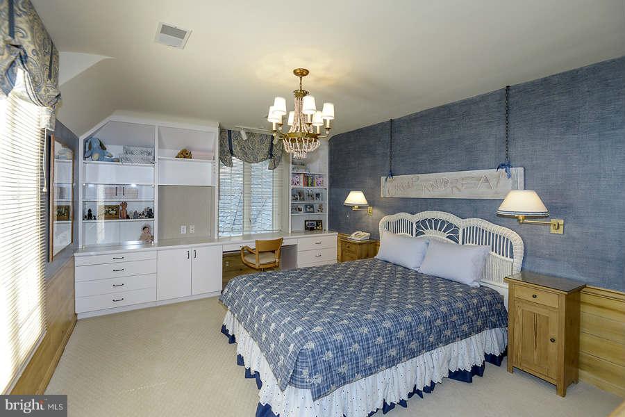 9017 Clewerwall Drive Bethesda, MD 20817 - Photo 18 of 27 a bedroom with a bed and window