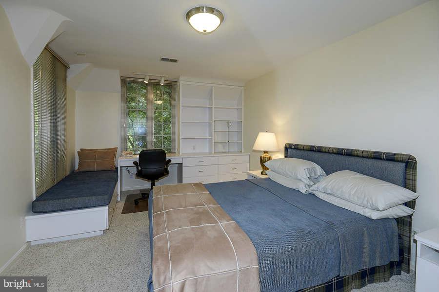 9017 Clewerwall Drive Bethesda, MD 20817 - Photo 19 of 27 a bedroom with a bed and wooden floor