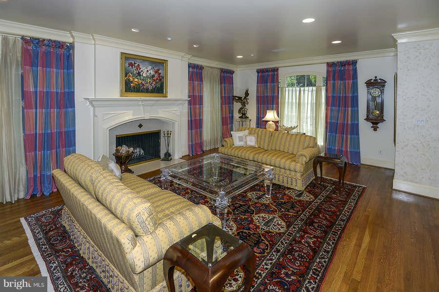 9017 Clewerwall Drive Bethesda, MD 20817 - Photo 5 of 27 a living room with furniture or couch and a fireplace