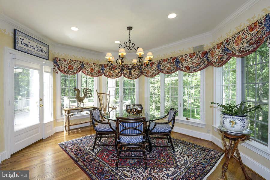 9017 Clewerwall Drive Bethesda, MD 20817 - Photo 9 of 27 a view of a dining room with furniture wooden floor and chandelier