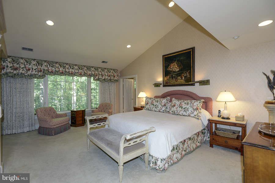9017 Clewerwall Drive Bethesda, MD 20817 - Photo 10 of 27 a bedroom with a bed and large windows