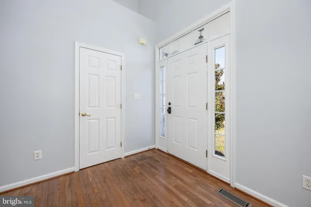 a kitchen with stainless steel appliances granite countertop a refrigerator a sink a stove top oven and a refrigerator