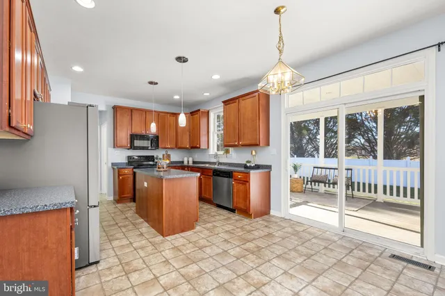 an empty room with closet and a chandelier fan