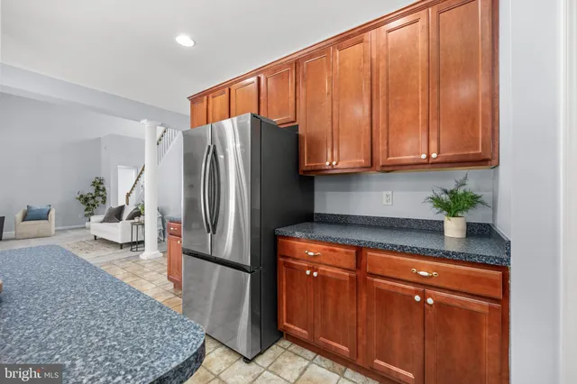 a white toilet sitting next to a white cabinet