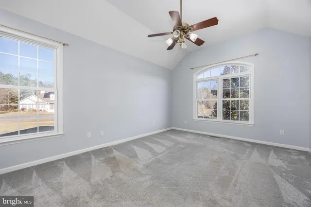 a view of a room with furniture and window