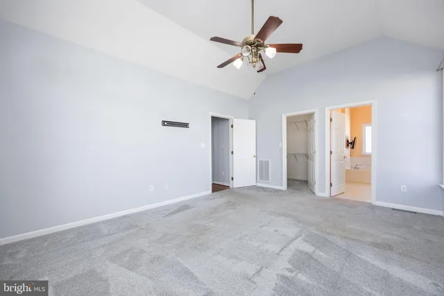 a view of a patio with a table and chairs and wooden fence