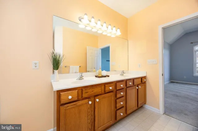 a view of a house with a yard and large trees