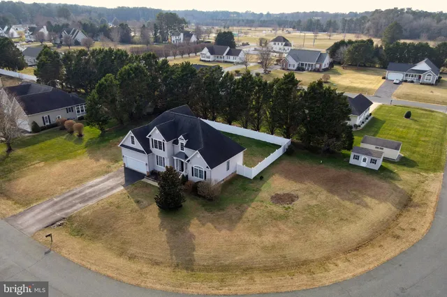 an aerial view of a house with a yard basket ball court and outdoor seating