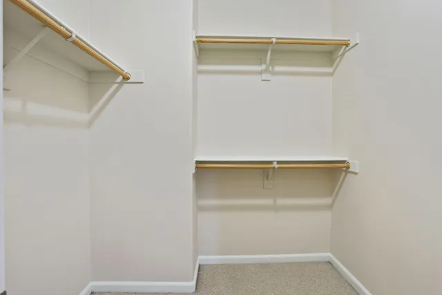 a bathroom with a granite countertop toilet a sink and a mirror