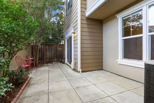 a backyard of a house with plants and trees