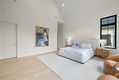 a spacious bedroom with a bed and a couch