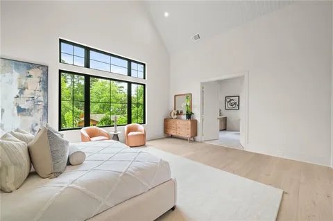 a bedroom with a bed and a large window