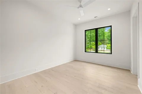 an empty room with windows and closet