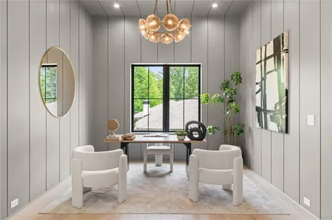 a living room with furniture a chandelier and a large window
