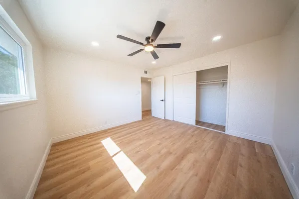 a view of a livingroom with a ceiling fan and window
