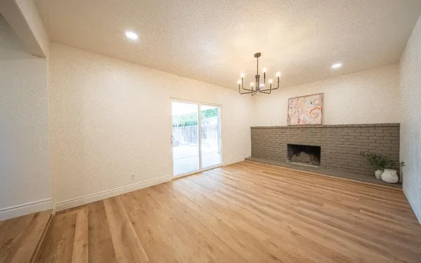 wooden floor in a room with a fireplace
