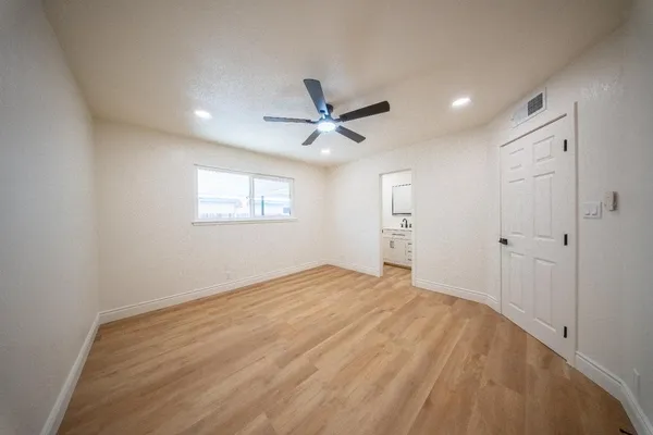 wooden floor in an empty room with a window