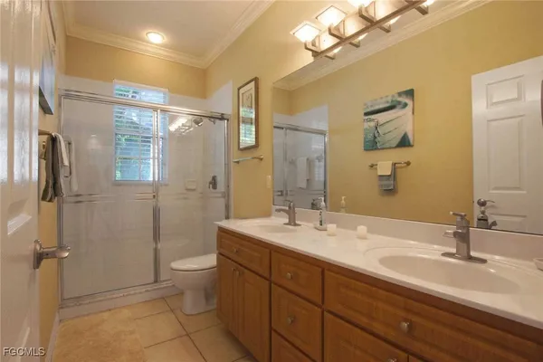 a bathroom with a sink a toilet a mirror and shower