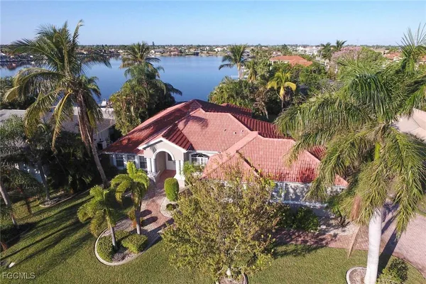 a view of a house with a yard and lake view