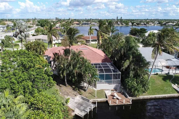 an aerial view of a house with a yard