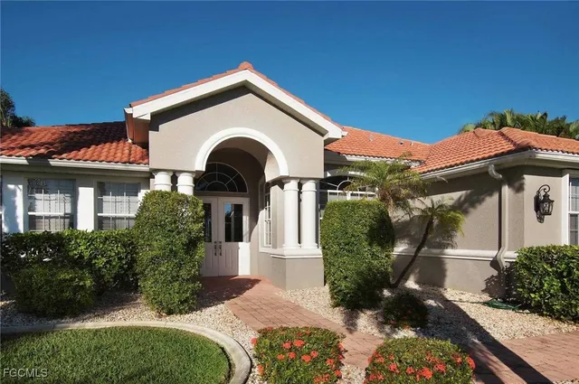 a front view of a house with garden