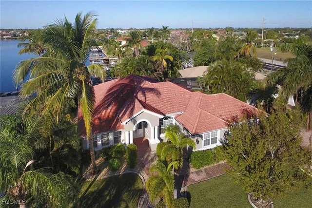 an aerial view of residential houses with outdoor space and trees