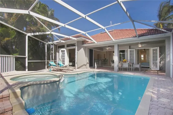 a view of a house with backyard porch and sitting area