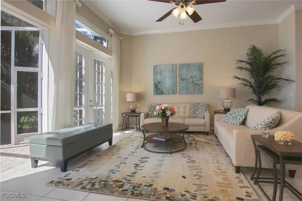 a living room with furniture windows and a table