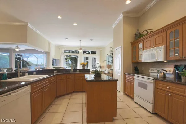 a kitchen with stainless steel appliances granite countertop a sink and cabinets