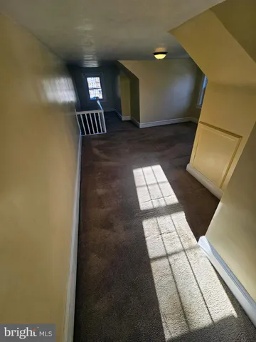 a view of an empty room and window and fire place