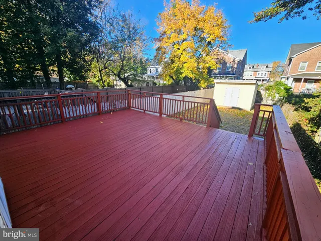 a view of a balcony with wooden floor and fence