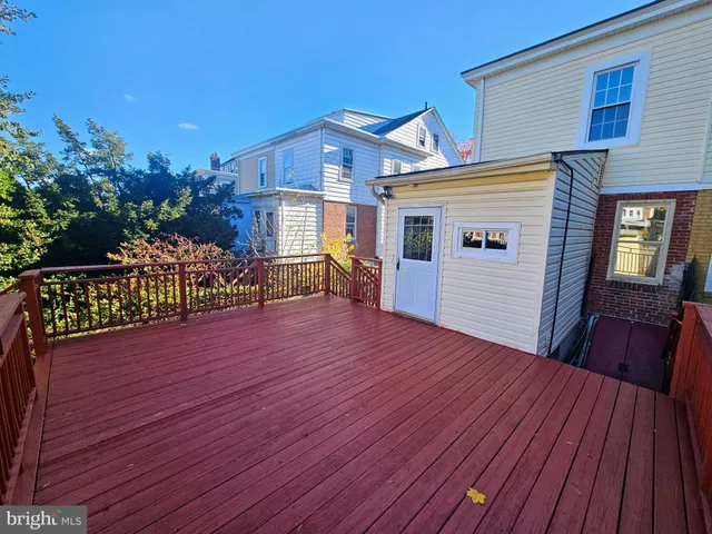 a view of a house with wooden deck