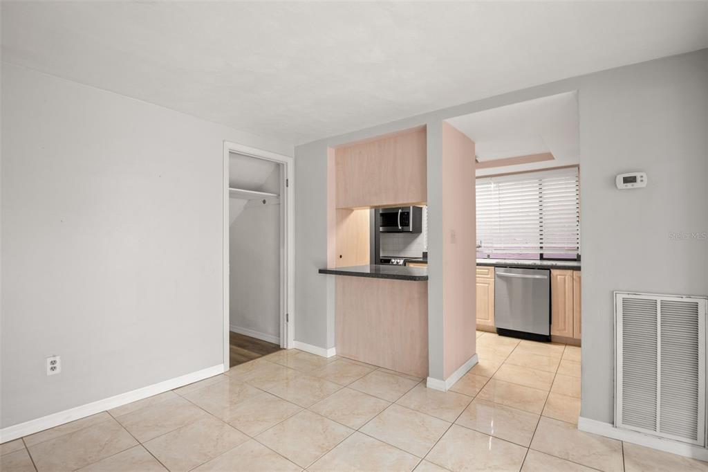 7500 Rocky Point Drive Hudson, FL 34667 - Photo 12 of 37 a kitchen with granite countertop a refrigerator and white cabinets