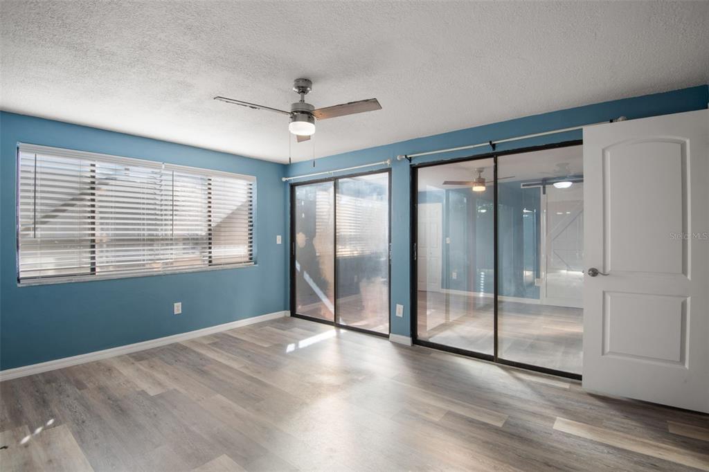7500 Rocky Point Drive Hudson, FL 34667 - Photo 22 of 37 a view of empty room with wooden floor and fan