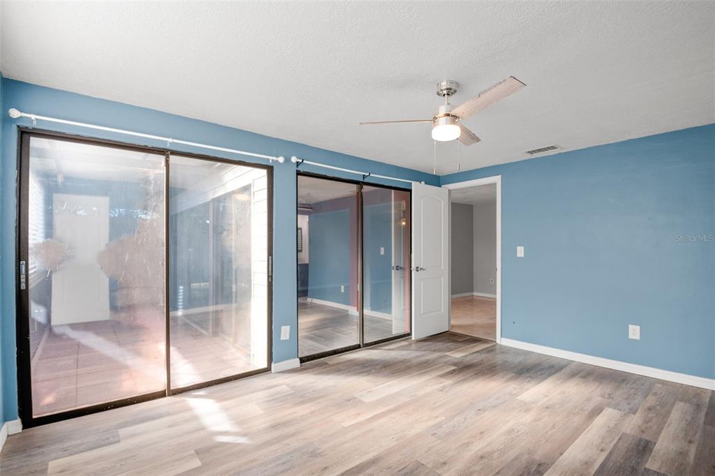 7500 Rocky Point Drive Hudson, FL 34667 - Photo 23 of 37 wooden floor in an empty room with a glass door
