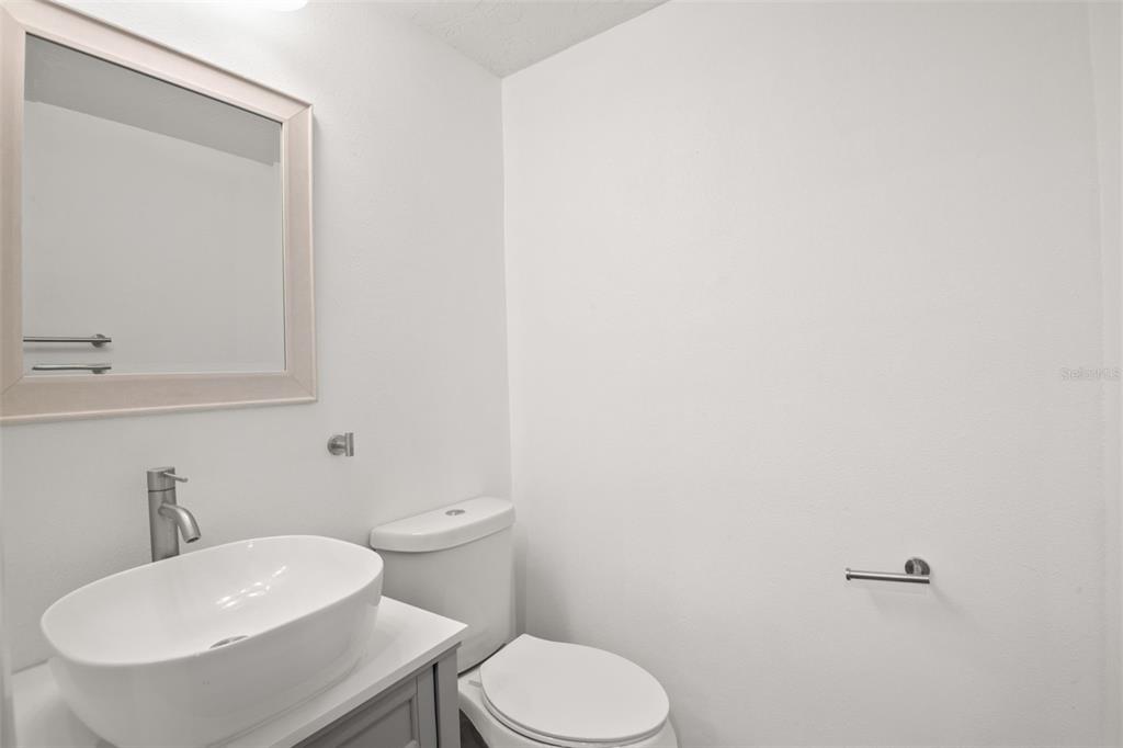 7500 Rocky Point Drive Hudson, FL 34667 - Photo 30 of 37 a bathroom with a toilet a sink and mirror