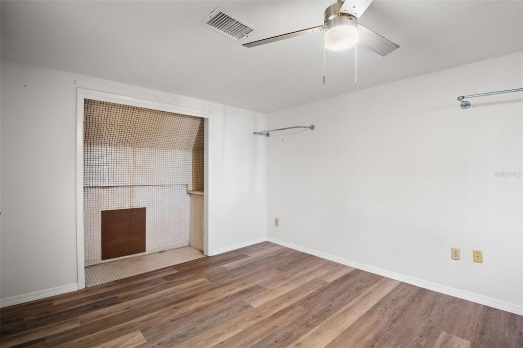 7500 Rocky Point Drive Hudson, FL 34667 - Photo 31 of 37 an empty room with wooden floor and cabinet