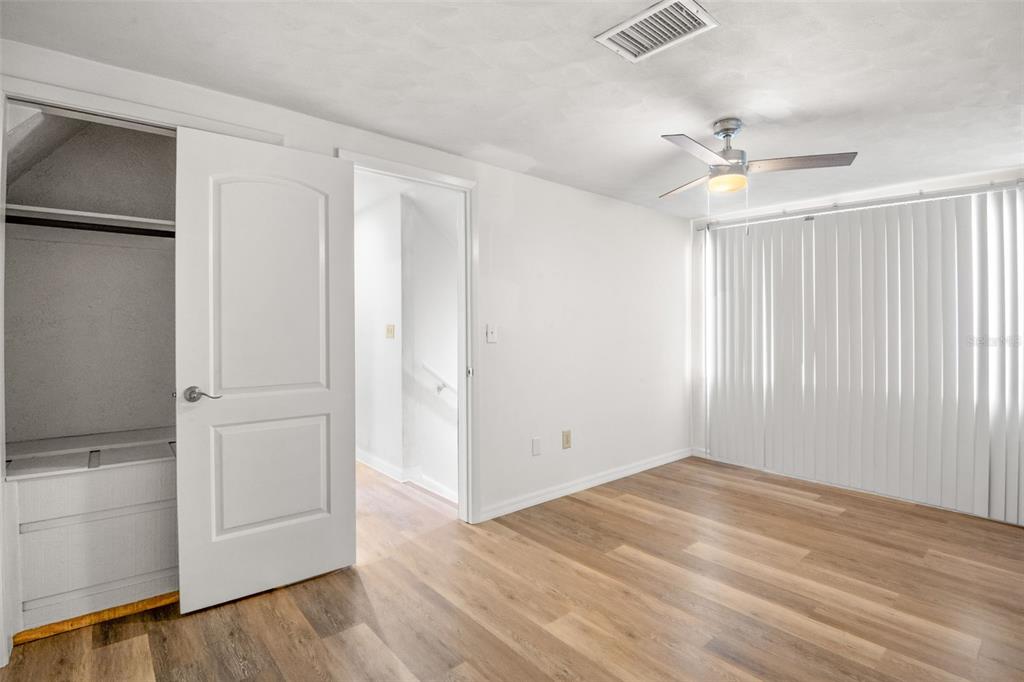 7500 Rocky Point Drive Hudson, FL 34667 - Photo 33 of 37 an empty room with wooden floor cabinet and windows