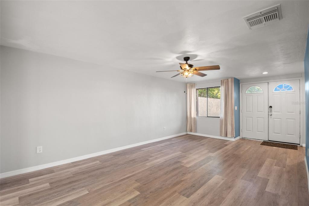 7500 Rocky Point Drive Hudson, FL 34667 - Photo 7 of 37 a view of a livingroom with a chandelier fan and window