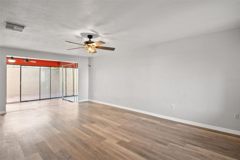 7500 Rocky Point Drive Hudson, FL 34667 - Photo 8 of 37 wooden floor in an empty room with a window