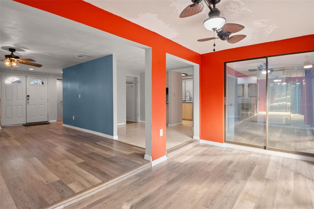 7500 Rocky Point Drive Hudson, FL 34667 - Photo 9 of 37 a view of a hallway with a chandelier fan and windows