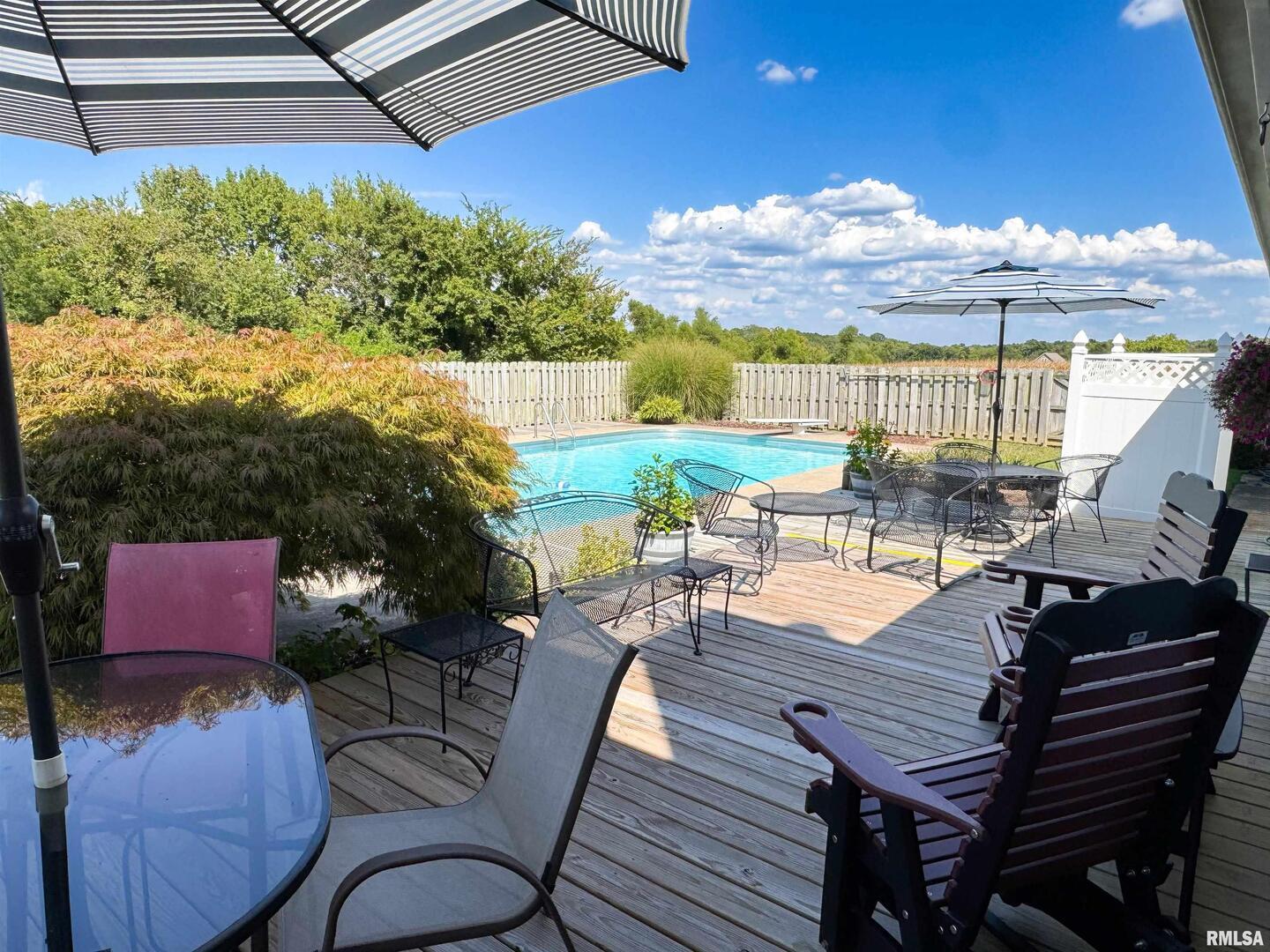 2885 State Route 146 Anna, IL 62906 - Photo 15 of 46 a view of a patio with couches table and chairs under an umbrella