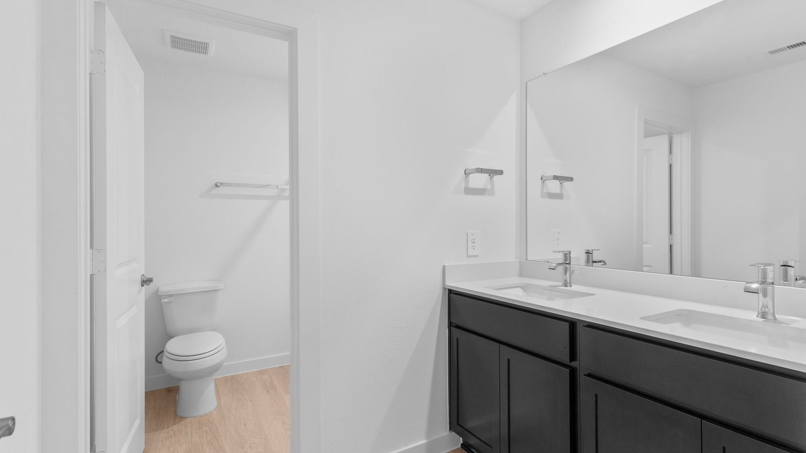 31319 Verona Ridge Drive Fulshear, TX 77441 - Photo 18 of 39 a bathroom with a granite countertop sink a toilet and a mirror