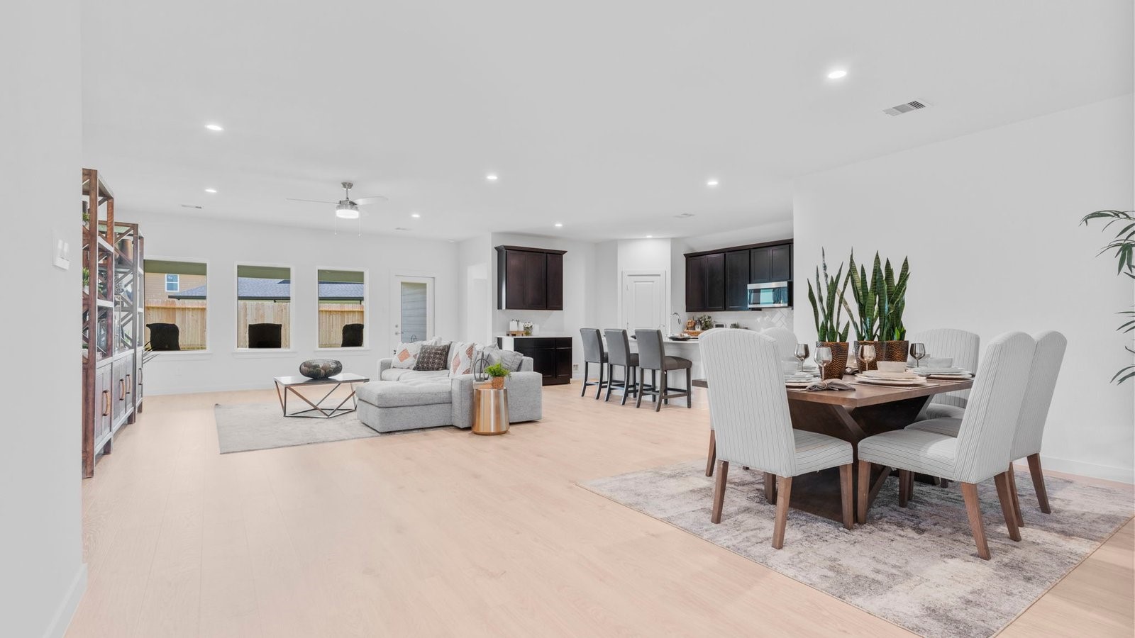 31319 Verona Ridge Drive Fulshear, TX 77441 - Photo 6 of 39 a living room with furniture a dining table and a potted plant