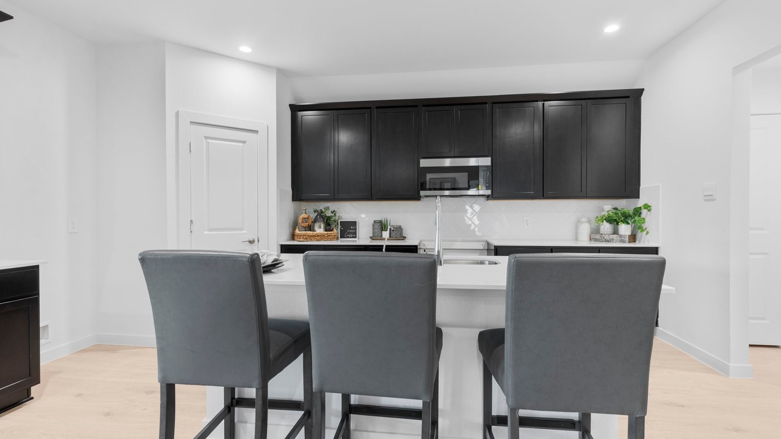 31319 Verona Ridge Drive Fulshear, TX 77441 - Photo 8 of 39 a living room with stainless steel appliances furniture a rug and a kitchen view